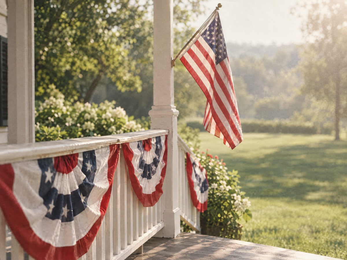 White porch railing with red, white and blue bunting and an American flag